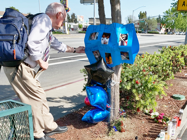 Joel Britton, SWP candidate for Congress, pays respects to Steven Taylor at memorial site set up by his family near Walmart in San Leandro, Calif., Cops gunned him down in store April 18.