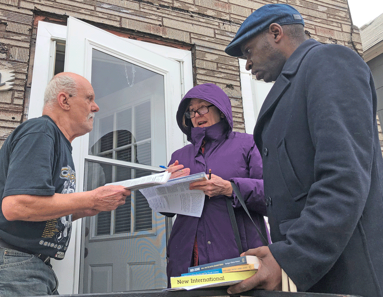 From right, Socialist Workers Party vice presidential candidate Malcolm Jarrett and campaigner Zena Jasper talk with retired truck driver Jerome Sotak in Whiting, Indiana.