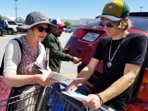 Garrett Bell picks up copy of Militant from Alyson Kennedy at Dallas area Walmart parking lot. 