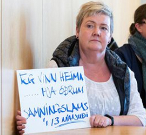 Solveig Anna Jonsdottir, chair of Efling Union and a cleaner, holds sign at May 5 union meeting: “I work at home ... other people’s homes, without a contract for 13 months.”