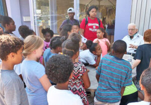 Allyn Gibson Sr. talking with children outside his Oberlin, Ohio, store. Appeal of court decision against Oberlin College officials deepens race-baiting smear campaign against Gibsons family.