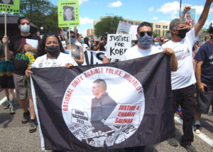 “The killings are not going to stop if we don’t fight,” said Jennie Ruiz, sister of Charlie Salinas, shot down and killed by cops in Sanger, California, in 2012. Ruiz, left, holding banner, marched in National Mothers March Against Police Violence in St. Paul, Minnesota, July 12.