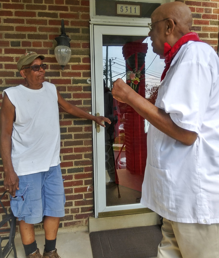 Omari Musa, right, SWP candidate for D.C. Congress delegate, speaks with retired worker James Cunningham June 27.