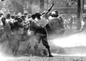 Civil rights protest attacked by cops in Birmingham, Alabama, 1963. Mass Black-led movement ended Jim Crow, advancing consciousness in whole working class against racism.
