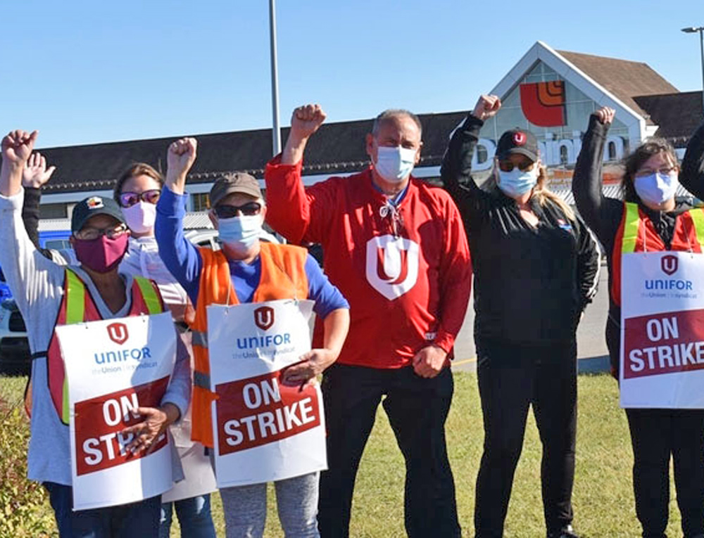 Grocery store workers, members of Unifor Local 597, picket Dominion store in Newfoundland, Canada. Some 1,400 have been on strike over past month against wage cut, for full-time work.