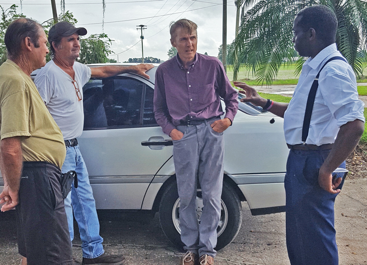 From left, retired farmers John and Robert St. Martin, and farmer Karl Butts discuss crisis facing working farmers with SWP vice presidential candidate Malcolm Jarrett and presidential candidate Alyson Kennedy, who took the picture, in Plant City, Florida, Sept. 28.