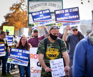 Workers march in Ilion, New York, Nov. 7, demand Remington Arms Co. honor union contract, give severance and vacation pay after plant shut down. Millions in U.S. have lost jobs.