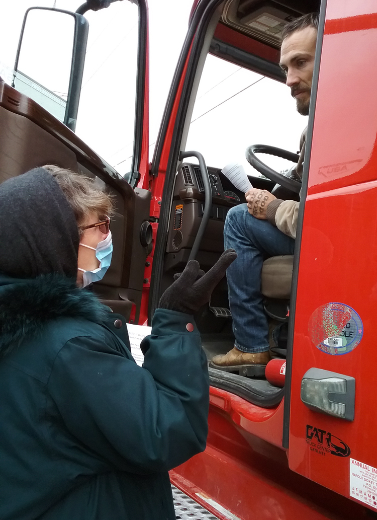 Rachele Fruit, SWP candidate for U.S. Senate from Georgia, talks with truck driver Cody Martin outside Hormel plant in Tucker, Georgia, Dec. 17. “Prices of essentials have been going up for years,” he said. Workers and our unions need to fight to keep people on the job, said Fruit, and for cost of living increases in all contracts to combat inflation.