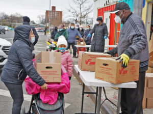 Volunteers at food pantry in Brooklyn in December distribute boxes of groceries to working families hit hard by prolonged unemployment. Jan. 6 disruption in Washington did not alter anything for working people as social, economic and moral crisis of capitalism continues.