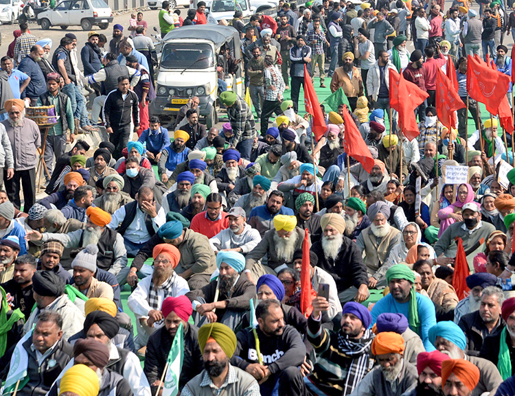 Farmers block Jalandhar-New Delhi National Highway during “chakka jam” protest Feb. 6 against new government laws ending state-backed minimum prices guaranteed to farmers.