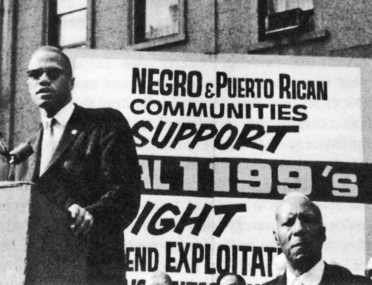 Malcolm X speaking at July 1962 New York rally called to support fight for union recognition by Local 1199. Malcolm praised Leon Davis, SEIU Local 1199 president, who spent 30 days in jail rather than comply with court order to call off 56-day strike by hospital workers.