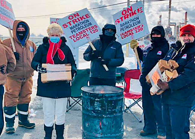 President of Minnesota Nurses Association delivers firewood donation to workers locked out by Marathon Petroleum in St. Paul Park, Minnesota. Strike support is crucial for the union.