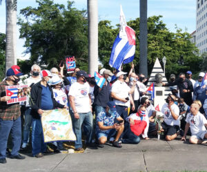 Caravan participants in Miami Jan. 31 protesting U.S. government embargo of Cuba rally at José Martí monument, above. Car caravans occurred in Seattle, Los Angeles and New York as well.