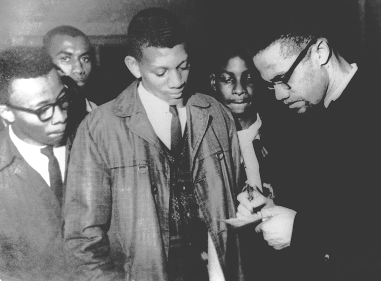 Malcolm X talks to students at Tuskegee Institute in Alabama, Feb. 3, 1965. Two months earlier at Oxford University in the U.K. he said, “I will join with anyone, I don’t care what color you are, as long as you want to change this miserable condition that exists on this earth.”