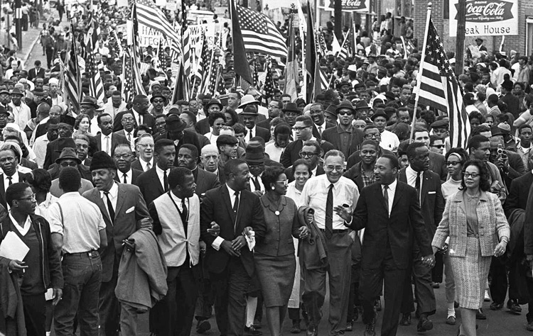 Demonstrators cross Edmund Pettus Bridge out of Selma, March 21, 1965, after victory in fight to march to state capital in Montgomery. Inset, days earlier, sheriff’s deputies attack protesters in Montgomery. Second from right is John Studer, who came to join the historic protests from Ohio. Stu-der is now editor of the Militant.