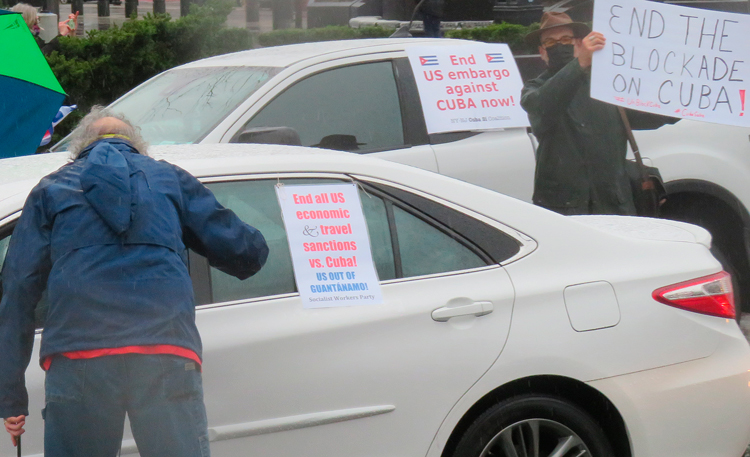 Carloads of protesters with Cuban flags and placards against U.S. embargo of Cuba assemble to drive through Harlem, New York, March 28 as part of international day of protest.