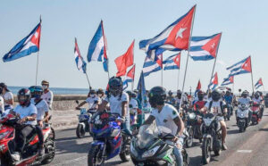 As part of international day of protest against Washington’s embargo against Cuba, motorcyclists ride along Havana’s famous Malecón esplanade March 28. They, and others in cars and on bicycles, chanted, “Down with the blockade!” as they passed the U.S. Embassy.