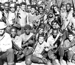Cuban militia members celebrate successfully defending their socialist revolution against an April 1961 invasion at Playa Girón fomented by the capitalist rulers in Washington.