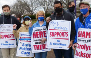 Nurses’ strike “is about safe care,“ nurse Bill Lahey, right, told rail workers Jacob Perasso, left, and Joe Allen, second from right, in Worcester, Mass., March 31.