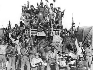 Cuban militia members celebrate victory over U.S.-backed mercenary invasion at Bay of Pigs in April 1961. Fidel Castro led toilers to deepen, defend first socialist revolution in the Americas.