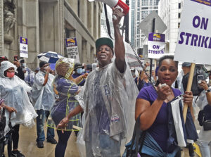 Over 400 hospital workers on strike in Chicago area rally June 29 outside Cook County president’s office in fight for more pay and against high cost of health care coverage.