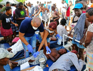 Volunteer Cuban health workers treat earthquake victims, other patients outside hospital in Corail, Haiti, Aug. 24. Cuban internationalists have worked continuously in Haiti for 22 years.