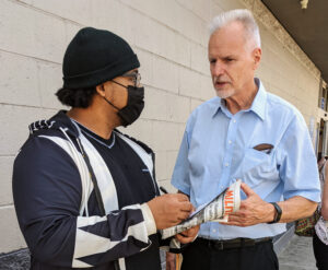 Dennis Richter, right, SWP candidate for governor of California, talks to Noble Kaus at San Leandro Walmart store Aug. 22. Richter urged Kaus, who works at a union-organized chocolate factory, to join in bringing solidarity to workers facing lockouts and strikes today.