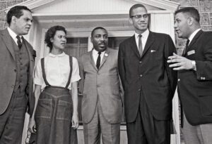 Meeting in Chester, Pennsylvania, hosted by Freedom Now Committee, March 14, 1964, to form Black rights group ACT. From left, Lawrence Landry, Chicago school boycott leader; Gloria Richardson; comedian Dick Gregory; Malcolm X; and Stanley Branche, committee chair.