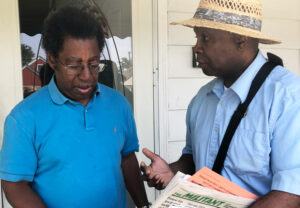 Socialist Workers Party campaigner Leroy Watson, right, discusses historic advances in fight against racism, including on strike picket lines, with Ben Allen, in Bellwood, Chicago, Aug. 1.