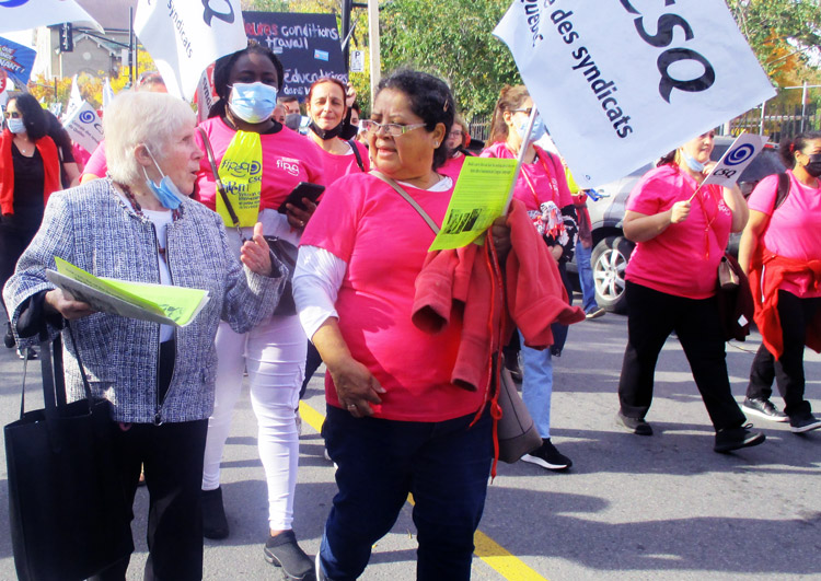 Beverly Bernardo, left, Communist League candidate for mayor of Montreal, marches with day care workers’ union in Montreal Oct. 12 during two-day strike over wages, working conditions.