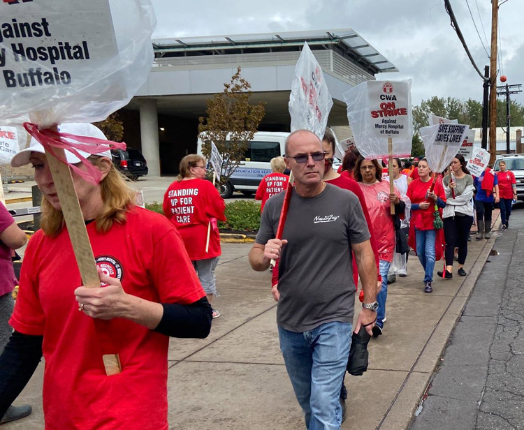 Striking health care workers picket at Mercy Hospital in Buffalo, New York, Oct. 12, on day 12 of their strike for safe staffing, higher wages, especially for lowest-paid workers.