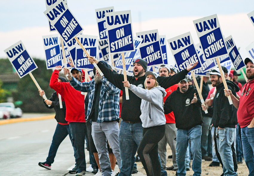 Picket at John Deere Davenport, Iowa, factory first day of strike Oct. 14 by 10,000 members of United Auto Workers. “We’re not going to sell new hires down the river,” said strikers.