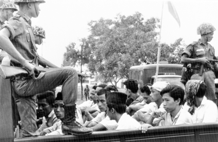 Indonesian Communist Party youth under guard by military, Oct. 30, 1965, after coup. Over a million were killed as counterrevolutionary Maoist misleaders led working people into a slaughter.