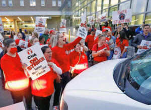 Strikers at Mercy Hospital in Buffalo, New York, face off against van carrying strikebreakers. Some 2,000 union members struck Oct. 1 over staffing shortages, unsafe working conditions.