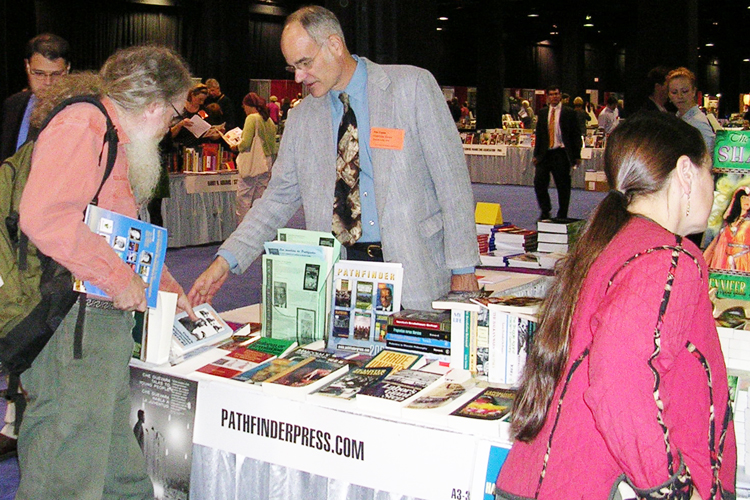 Supporters of the Socialist Workers Party organize production and distribution of Pathfinder books by party leaders and other revolutionary fighters. Above, Tim Craine staffs Pathfinder Press table at New England Booksellers Association trade show in Boston in 2004.