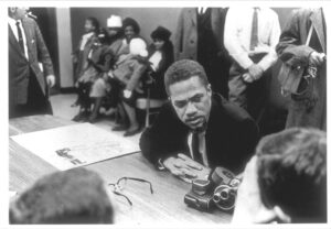 Malcolm X meets reporters in New York, Nov. 24, 1964, after his second trip to Africa. Malcolm said the trip showed him the need to involve all “true revolutionaries dedicated to overthowing the system of exploitation that exists on this earth,” like in the Algerian and Cuban revolutions.