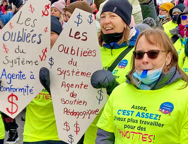 Nov. 23 rally in Montreal by public sector day care workers, part of 12-day strike that won new contract. T-shirt reads: “Enough is enough! I will no longer work for peanuts!”