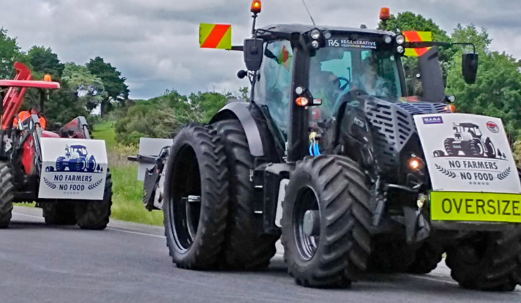 Tractor and “ute” farm vehicles caravan into Auckland, New Zealand, Nov. 21. Thousands across country protested Labour government regulations, taxes imposed in name of defense of the environment that attack working farmers’ livelihoods and their care for the land.