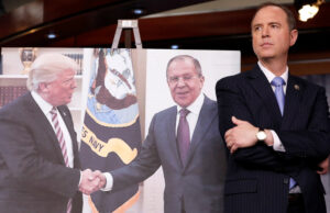 Adam Schiff, Democrat chair of House Intelligence Committee, displays blown-up picture of President Donald Trump meeting Russian Foreign Minister Sergei Lavrov. Democrats mounted furious campaign against Trump based on false claims from now discredited Steele dossier, inset.