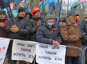 Miners protest in Kyiv, Ukraine, Dec. 16, after not receiving millions in back pay or funding for health and safety measures. Signs read “Our families” and “our children also want to eat.”
