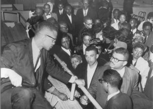 Malcolm X meets crowd at March 22, 1964, rally in Harlem. After breaking with Nation of Islam, Malcolm emerged as “the face and authentic voice” of the coming American revolution.