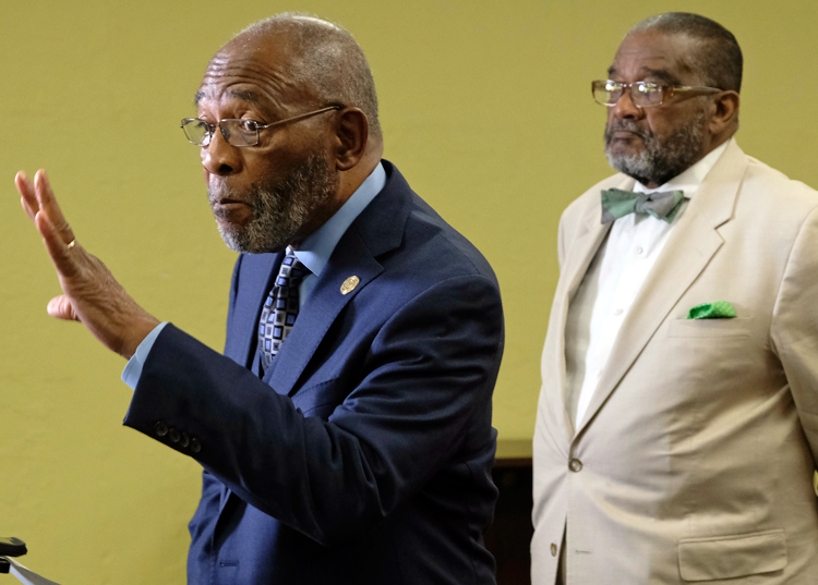 Dr. Amos Brown, left, San Francisco NAACP president, speaks against school board moves in 2019 to cover up mural at George Washington High School. Right, Rev. Arnold Townsend.