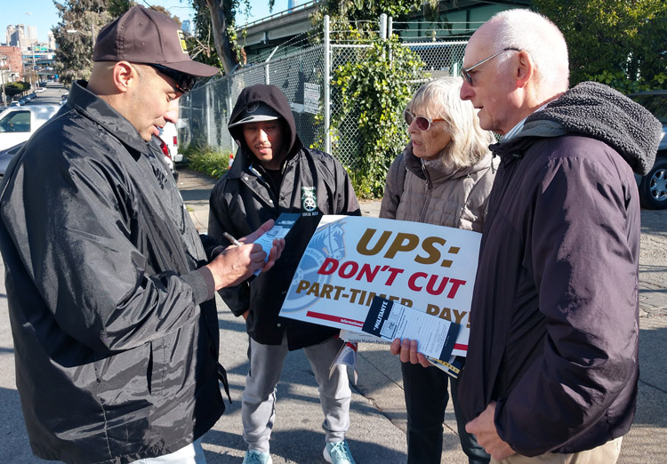 UPS worker Mark Rodriguez, left, renews Militant subscription at Teamster protest against pay cut for part-time workers Feb.23, San Francisco. At right, Joel Britton, SWP candidate for California governor. SWP has launched Militant drive to advance fight against Moscow’s war.