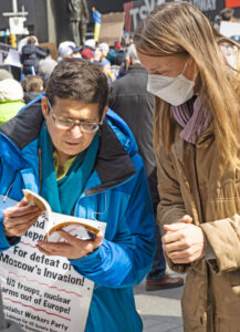 Sara Lobman, left, Socialist Workers Party candidate for U.S. Senate, campaigns at protest of thousands in solidarity with Ukraine in New York’s Times Square March 5.