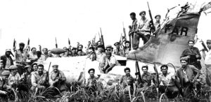 Celebrating defeat of Washington’s Bay of Pigs invasion by 1,500 U.S.-organized mercenaries, April 1961, Cuban militiamen pose with wreckage of downed U.S. plane in fake Cuban colors. Fidel Castro said U.S. imperialists couldn’t forgive the workers and peasants of Cuba for “making a socialist revolution right under their very nose.”