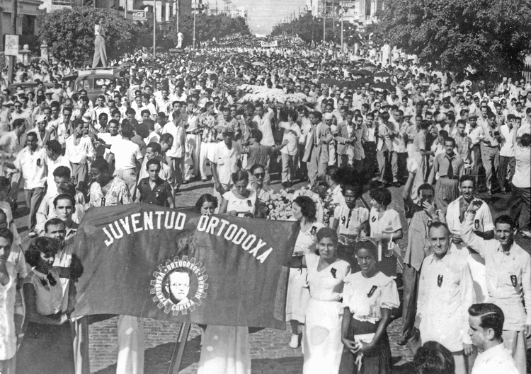 Banner of revolutionary-minded youth movement of Orthodox Party leads march against coup by U.S.-backed Fulgencio Batista in Havana in 1952. From these beginnings, Fidel Castro organized the July 26 Movement, which led working people to take power into their own hands.
