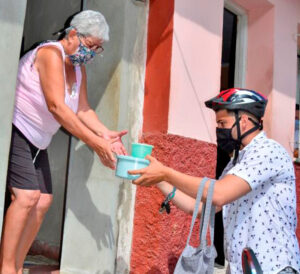 Food delivery during peak of pandemic in May 2020. Health care workers and other Cubans are proud of role they played in combating pandemic and at Cuba’s 90% vaccination rate.