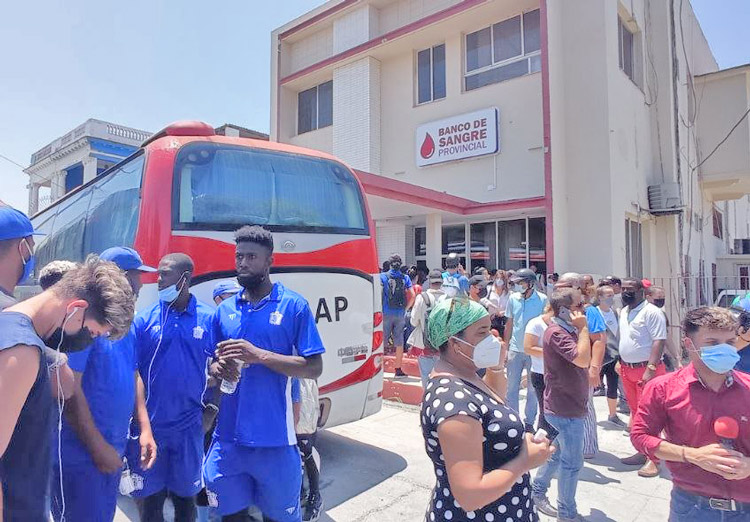 Members of well-known Havana baseball team, Industriales, left, gather May 6 along with other Cubans to donate blood shortly after devastating explosion at Hotel Saratoga.