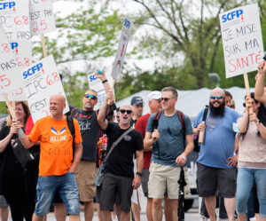 Canadian Union of Public Employees members picket Montreal casino May 21 in strike over working conditions that cause repetitive motion injuries. Sign at right says, “I bet on my health.”