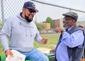 At the Philadelphia May Day event, Osborne Hart, right, Socialist Workers Party candidate for U.S. Senate from Pennsylvania, talks to construction worker Adrian Andrade. “We work really hard for very little pay,” Andrade said as he subscribed to the Militant.